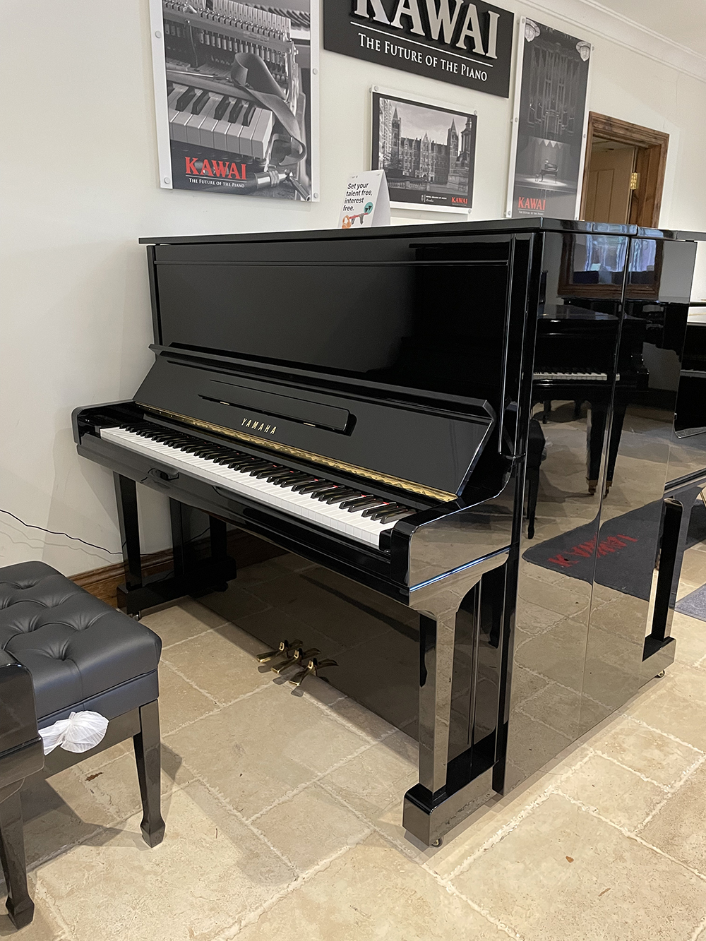 Restored Yamaha U300 upright piano in high gloss black